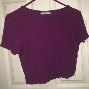 pinkish purple cropped top with detail on sleeve.